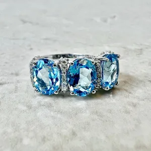 14 Karat White Gold Oval Swiss Blue Topaz & Diamond Three-Stone Ring