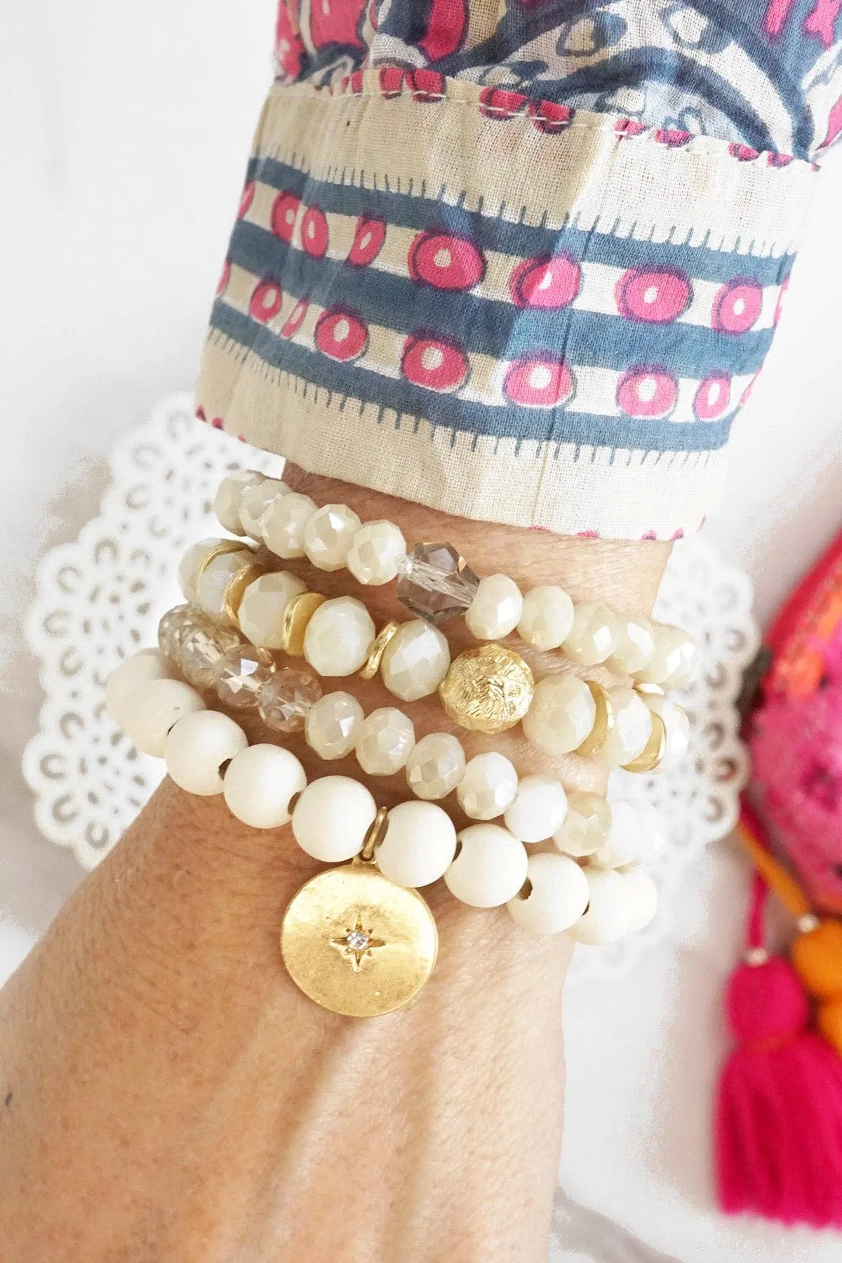 Beaded bracelets set in White Cream with a coin charm